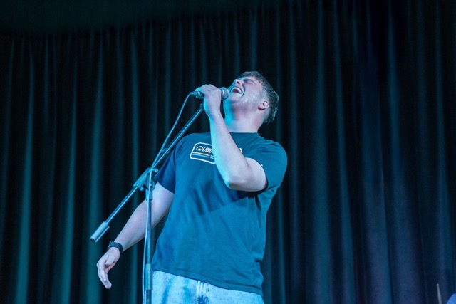 Singer under blue stage lights